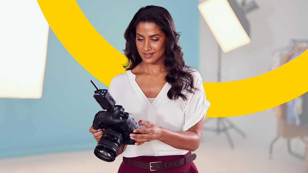 A woman looking at a professional camera ahead of Making Tax Digital